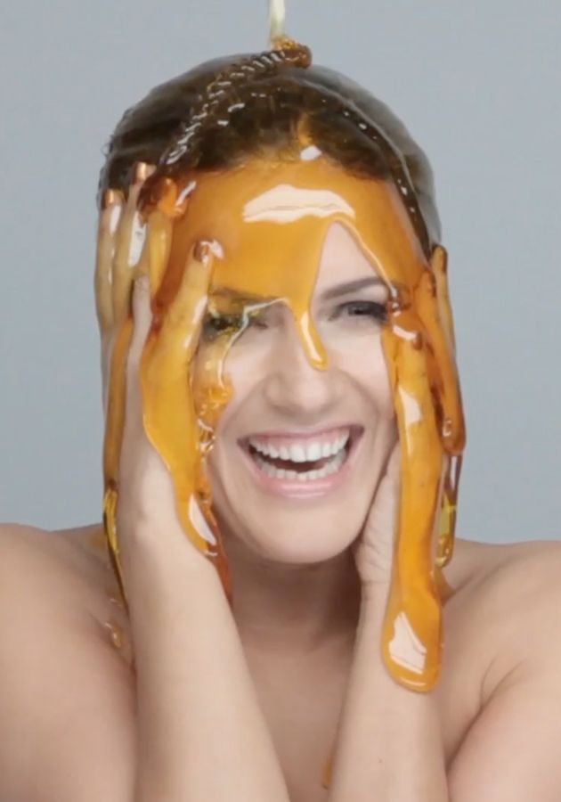 girl getting honey poured on her head. raw honey all over your face.